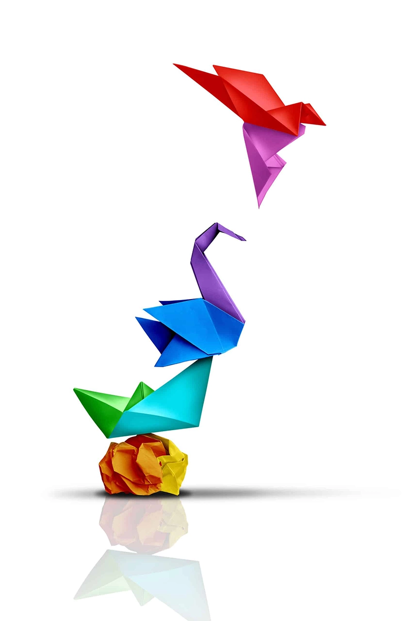 Colourful origami birds on a white background depicting the challenges of creating an innovation strategy